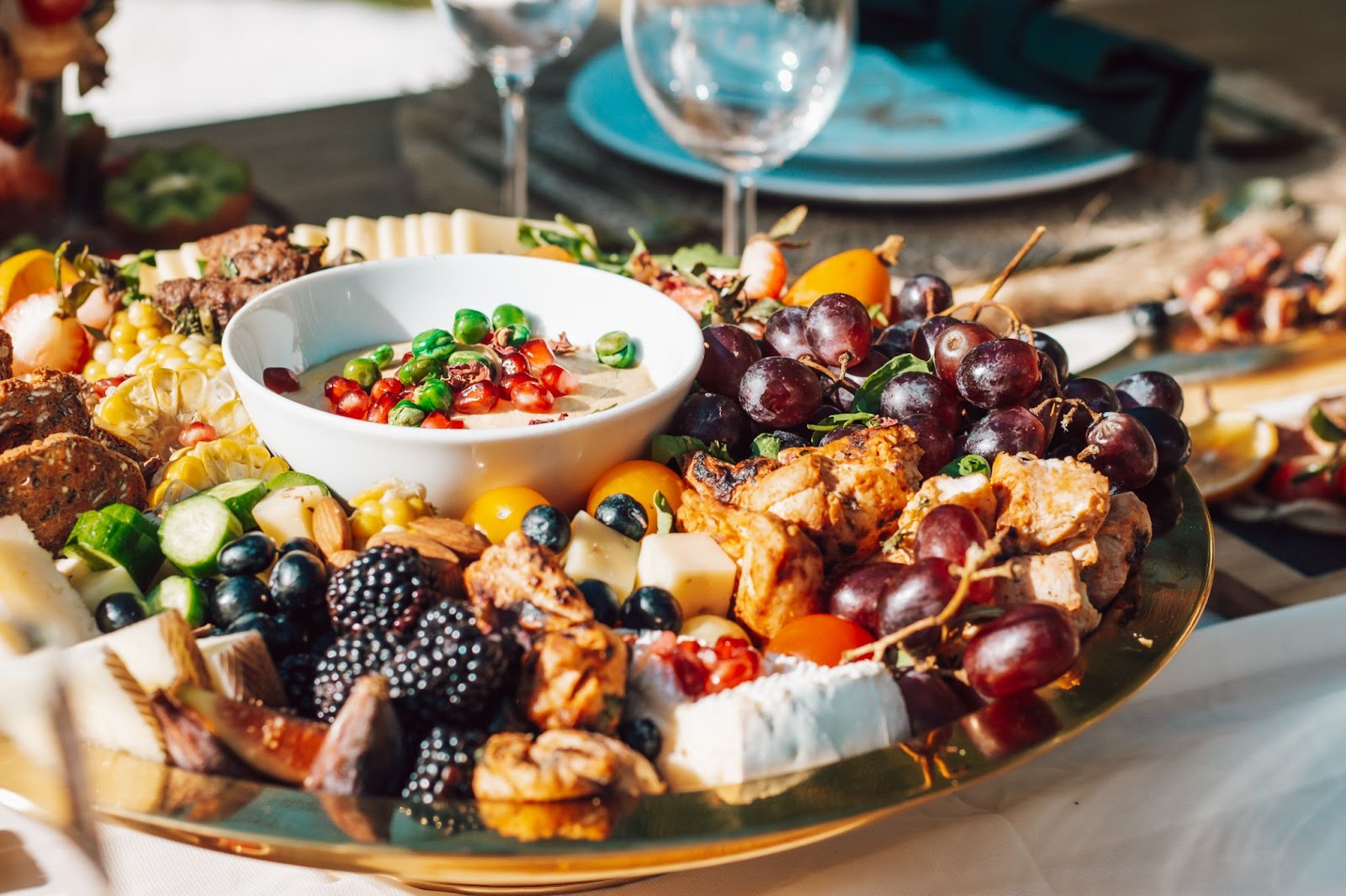 Platter of food with grapes, cheese and vegetables