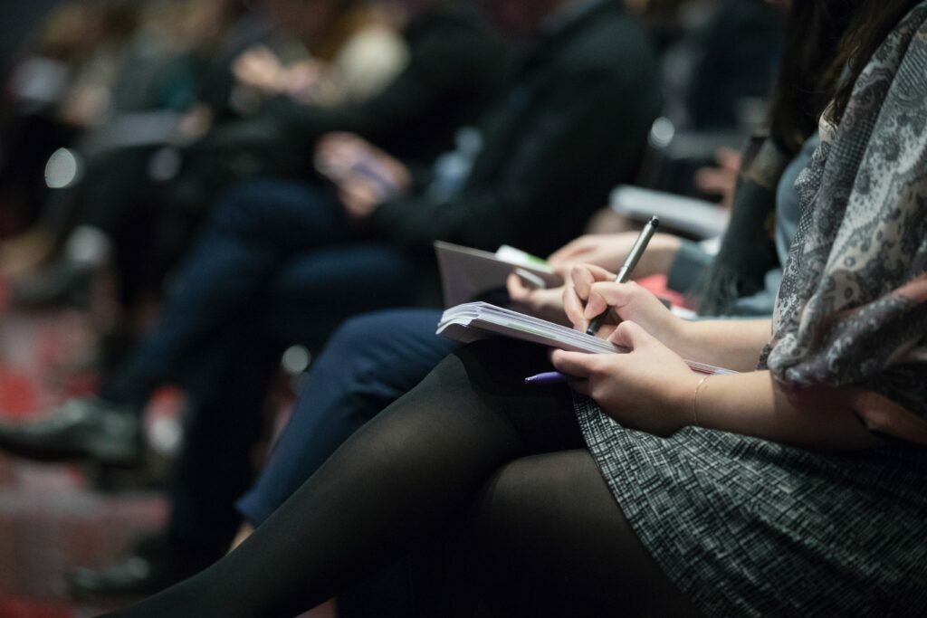 Journalists taking notes at press conference