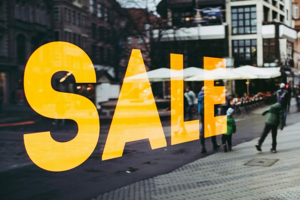 Enormous yellow sale sign on window