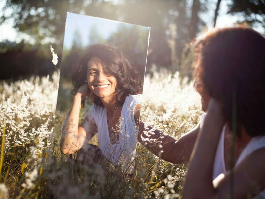 Woman looking at herself in a mirror