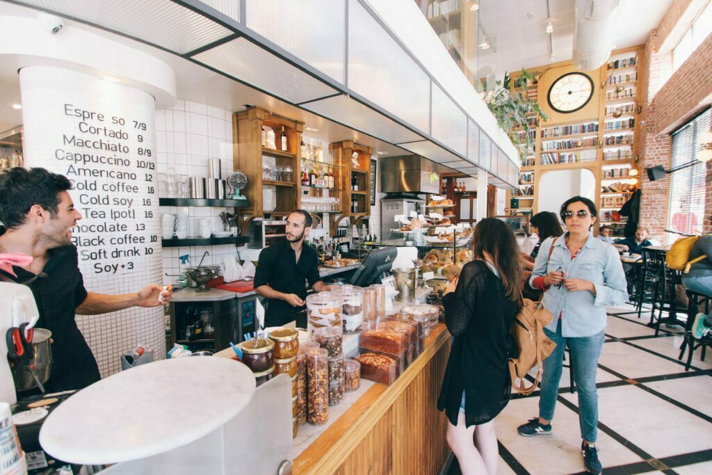 Customers making transactions at a coffee shop