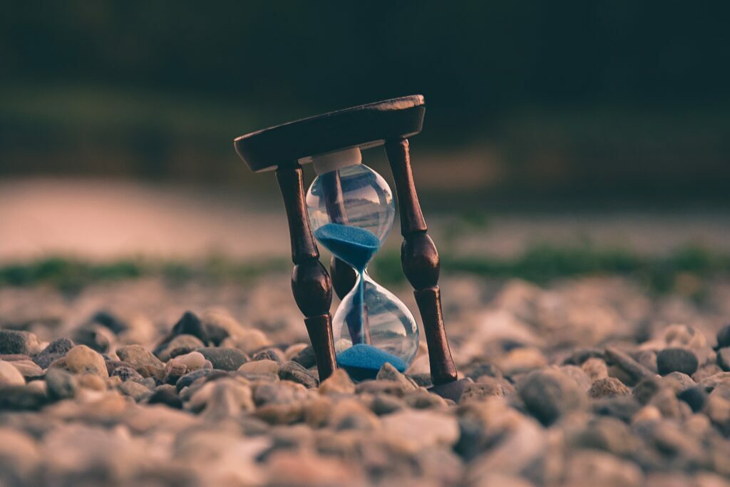 Blue hourglass on stones