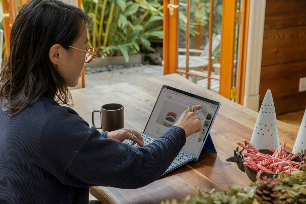 Woman using laptop to track her business' marketing activities