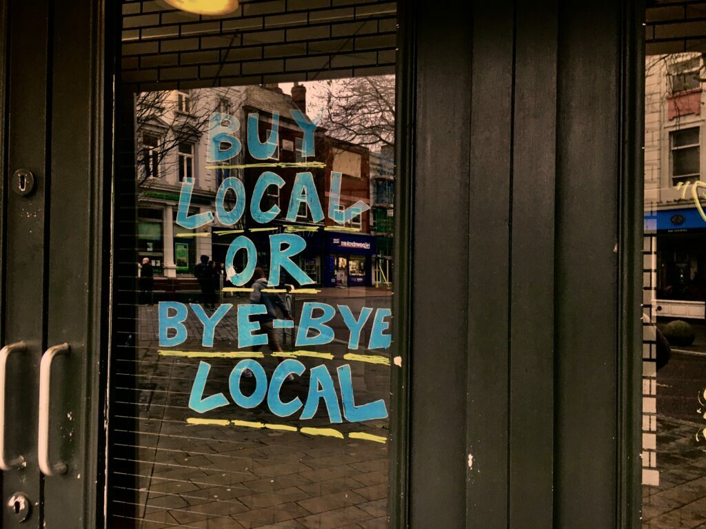 Blue sign on the window of a local shop
