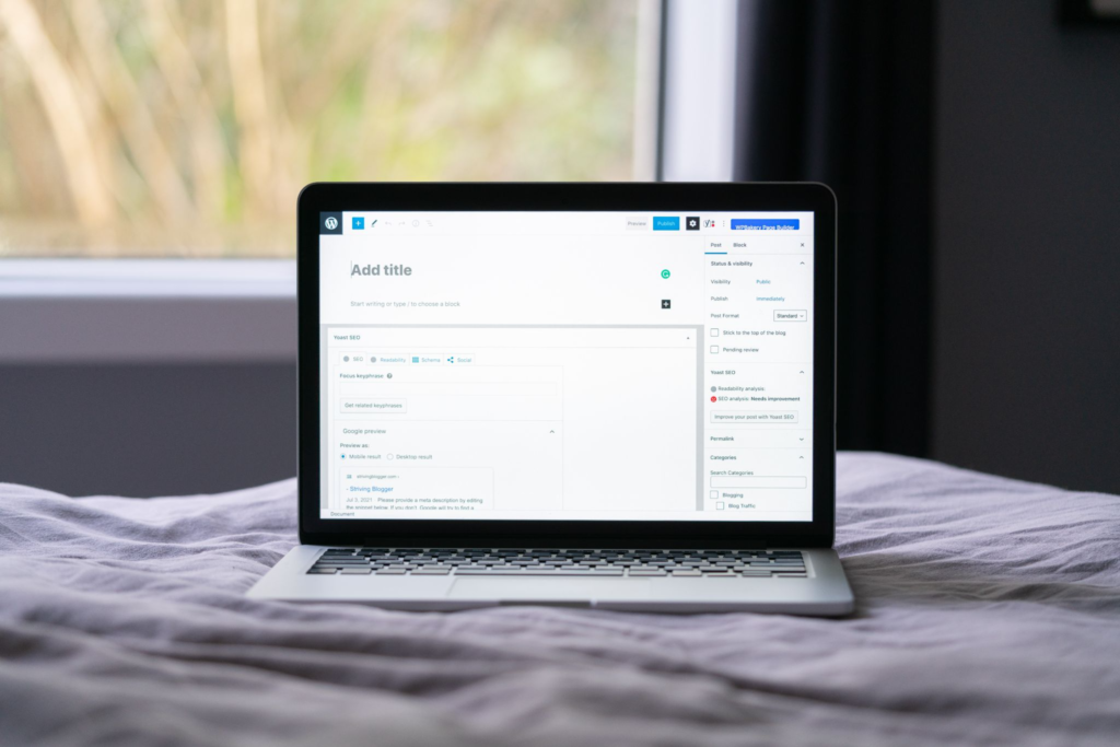 Laptop on bed displaying WordPress blog builder